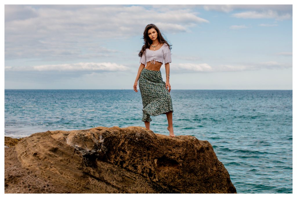 Stylizacja na wakacje z białym crop topem i wzorzystą spódnią